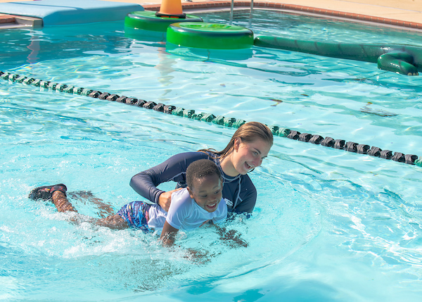 instructor and student during swim lessons