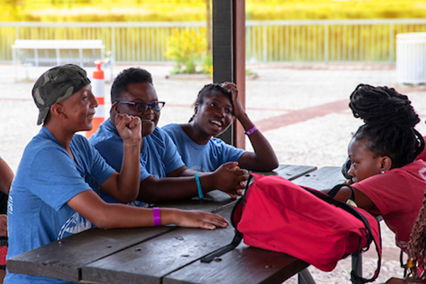 Teens talking at a table