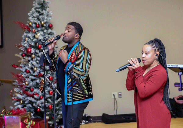 singers at holiday hop event