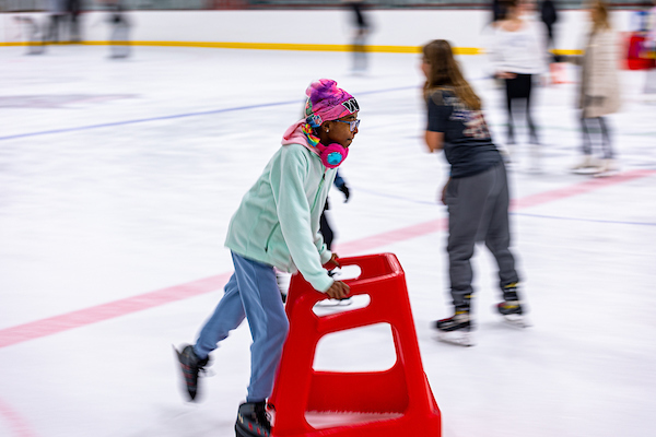 ice skating participant using assistive device