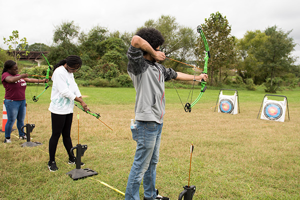 Teens practicing Archery