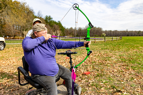 man using adaptive archery equipment