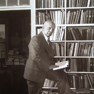 Man standing in front of bookshelf looking at camera
