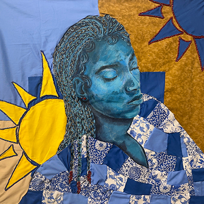 A brightly yellow and blue colored quilted fabric that depicts a woman with her eyes closed.