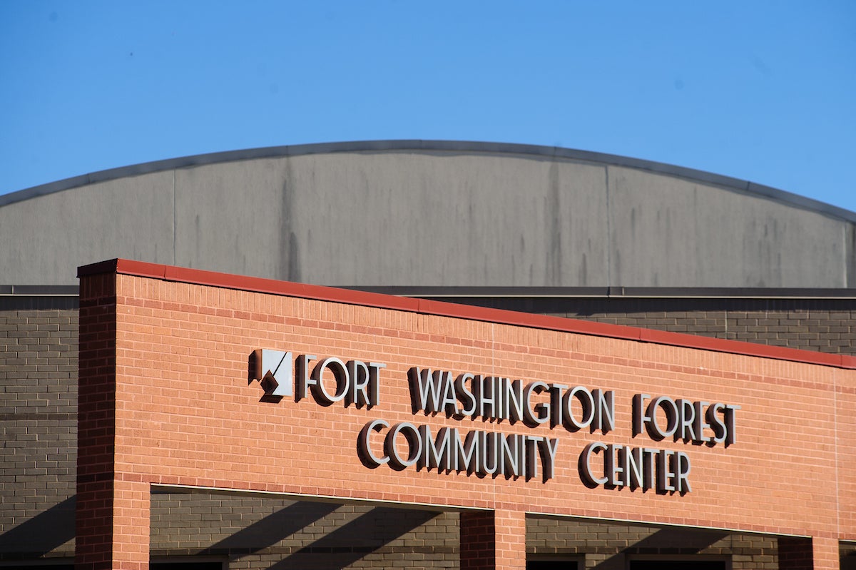 Close-up view of the words FORT WASHINGTON FOREST COMMUNITY CENTER on the red brick facade of a building.
