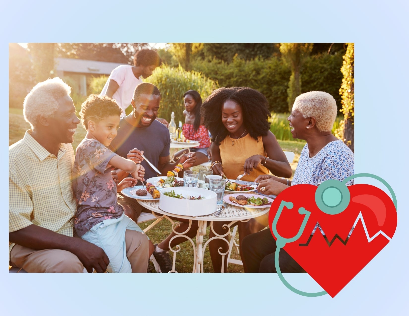 A smiling family sits around a small cafe table in the grass, eating plates of food. Superimposed over this image is a blue frame and a heart graphic with a stethoscope wrapped around it.
